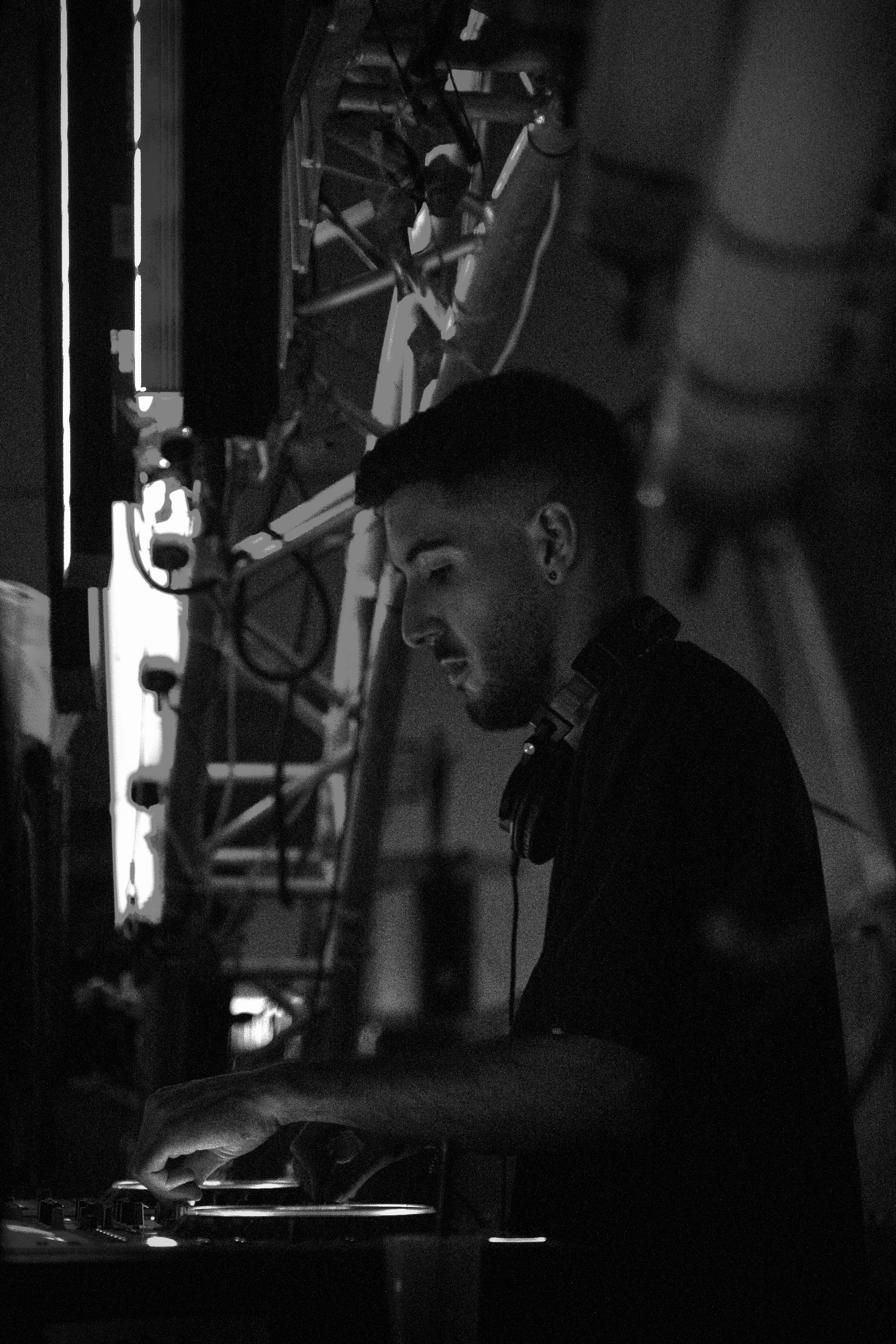 1LINE behind the decks, lit from the booth